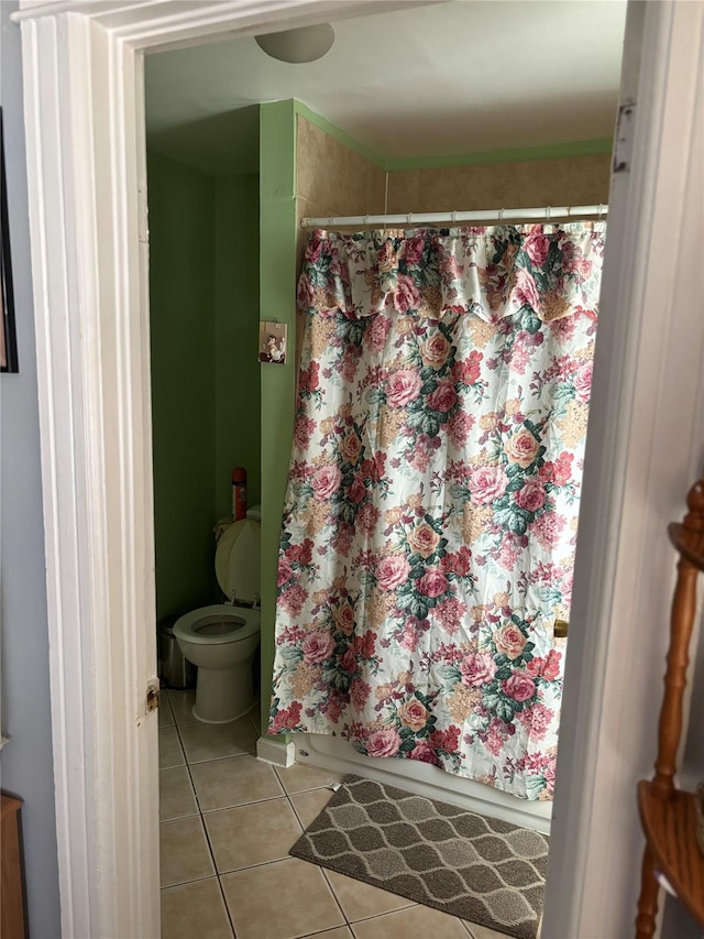 bathroom with toilet and tile patterned flooring