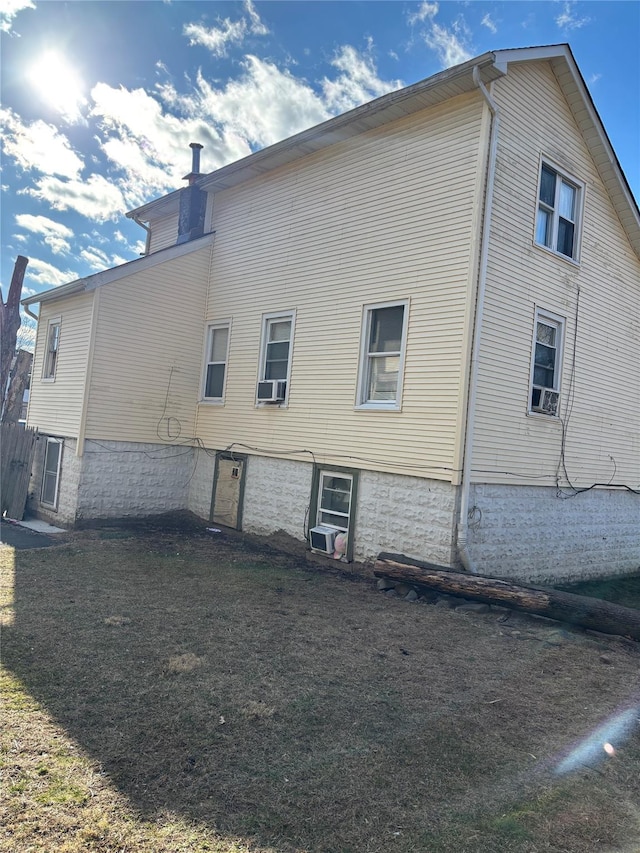 view of side of home featuring cooling unit