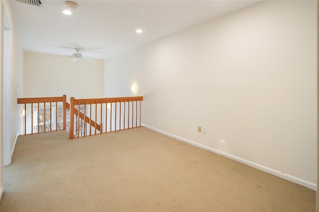 spare room featuring carpet and ceiling fan