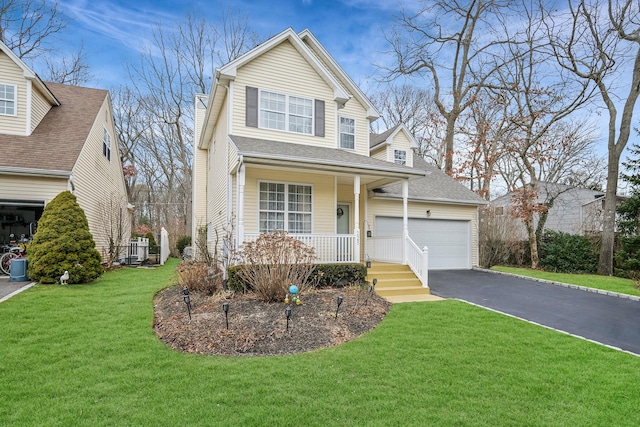 view of front of house featuring a porch, a garage, and a front yard