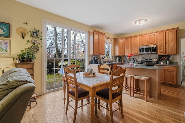 dining area with light hardwood / wood-style flooring and sink