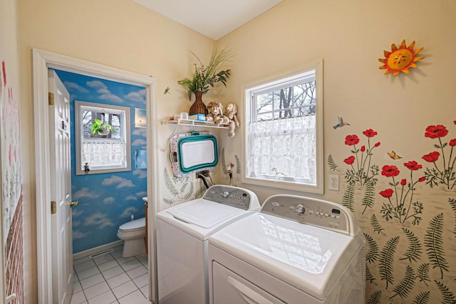 laundry area featuring light tile patterned flooring and washing machine and clothes dryer