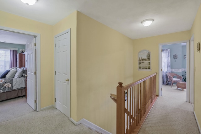 hallway featuring light colored carpet