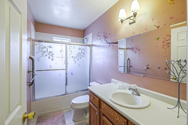 full bathroom with toilet, bath / shower combo with glass door, tile patterned floors, and vanity