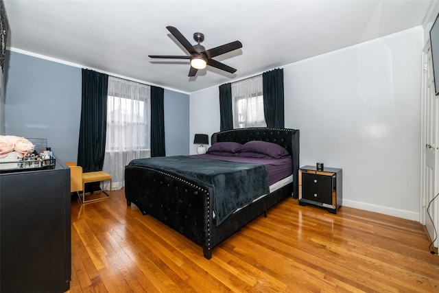 bedroom with ceiling fan and hardwood / wood-style floors