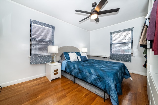 bedroom with ceiling fan and wood-type flooring