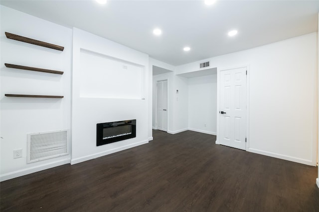 unfurnished living room featuring dark wood-type flooring