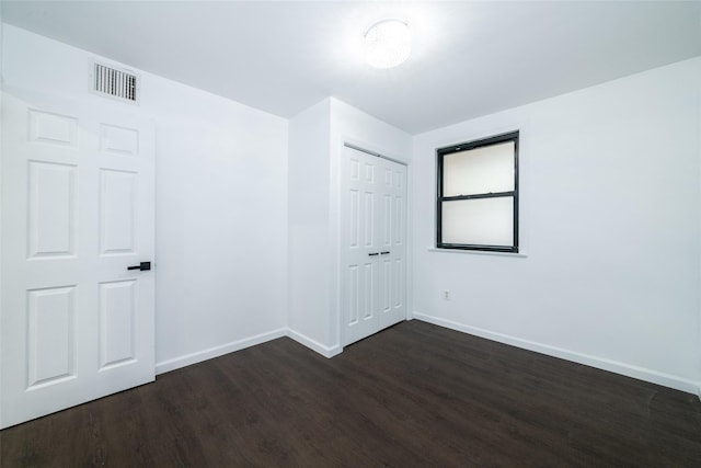 empty room featuring dark wood-type flooring