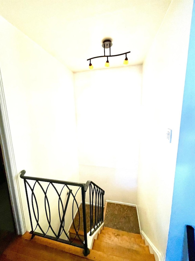 stairway with rail lighting and baseboards