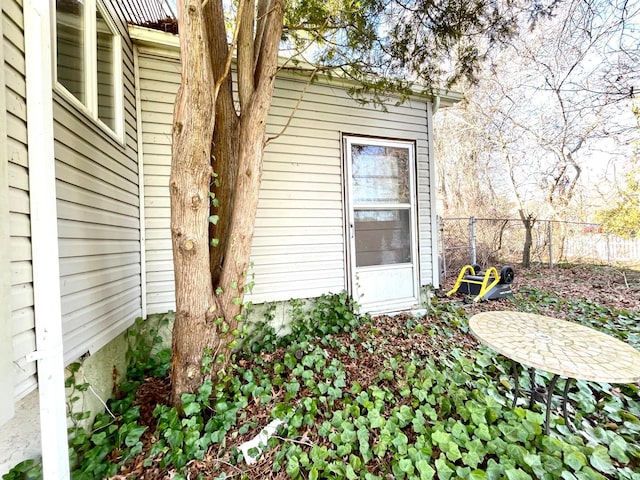 view of exterior entry with fence