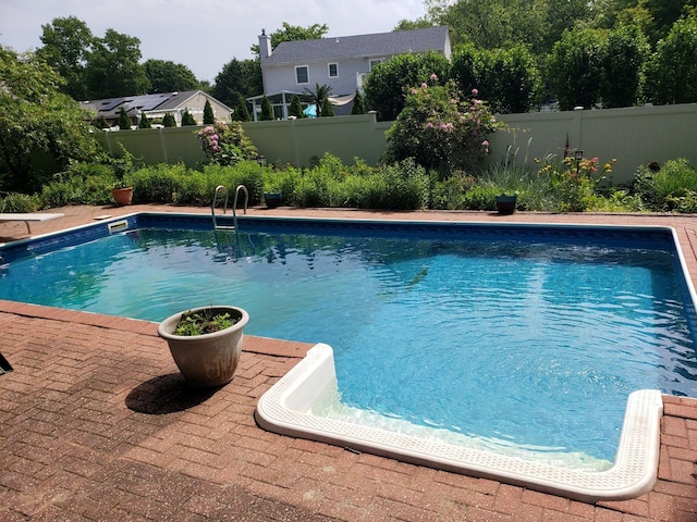 view of pool with a fenced backyard and a fenced in pool