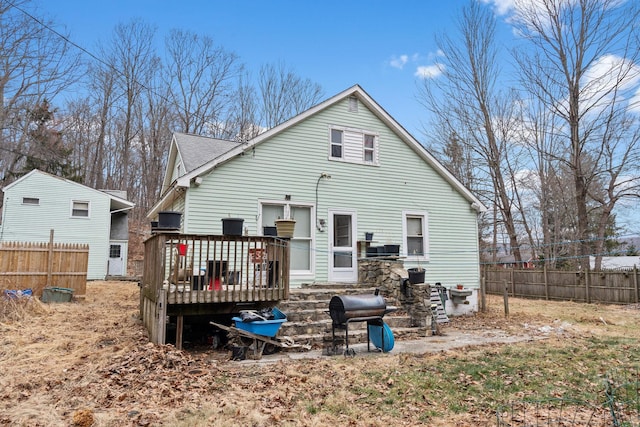 rear view of property featuring a deck