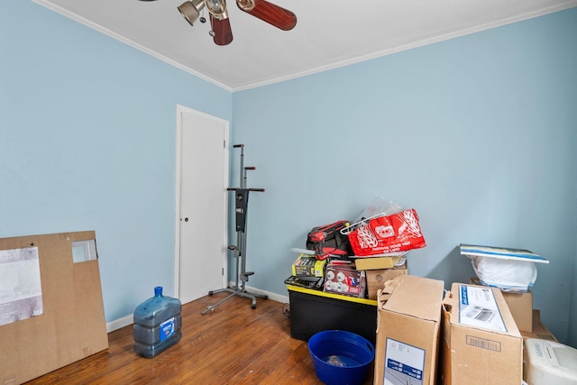 miscellaneous room with dark wood-type flooring, ceiling fan, and ornamental molding