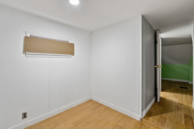 spare room with hardwood / wood-style flooring