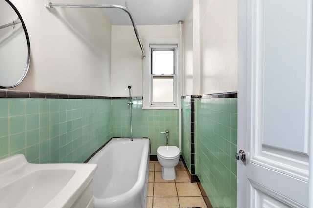 bathroom featuring tile walls, sink, tile patterned floors, and toilet