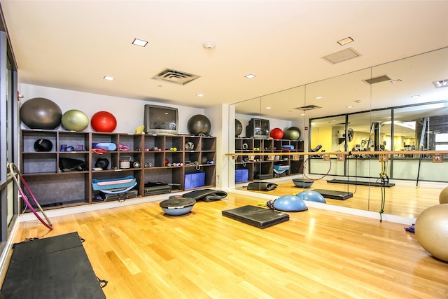 gym with hardwood / wood-style flooring