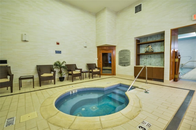 view of swimming pool with an indoor in ground hot tub and a swimming pool