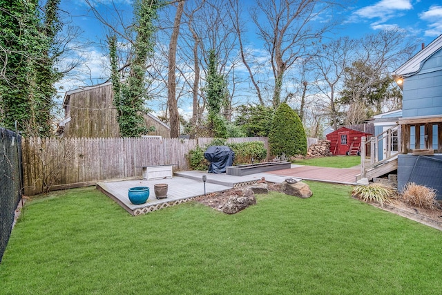 view of yard featuring a deck and an outbuilding