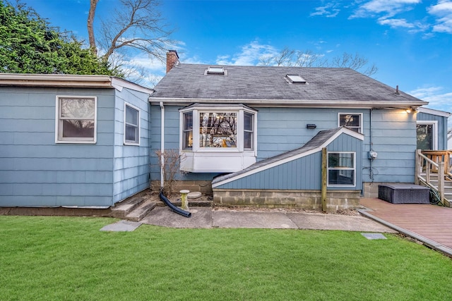 rear view of property featuring a lawn