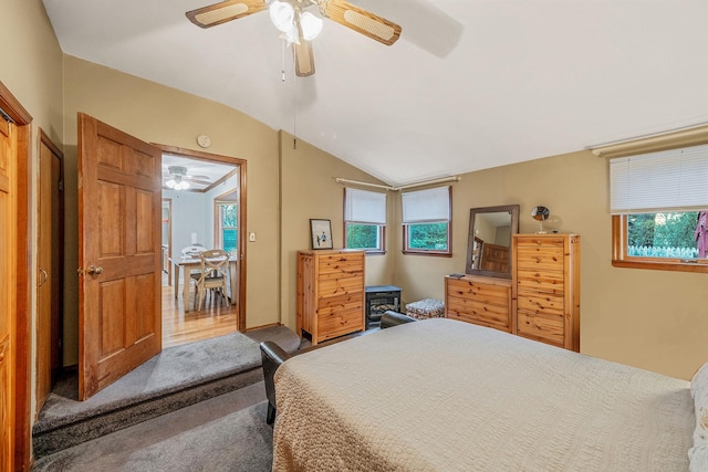 bedroom featuring lofted ceiling, ceiling fan, and carpet