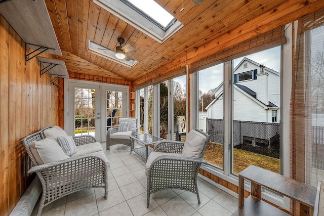 sunroom / solarium featuring ceiling fan, vaulted ceiling with skylight, and wood ceiling