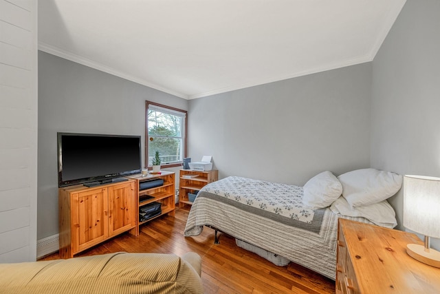 bedroom with hardwood / wood-style flooring and ornamental molding