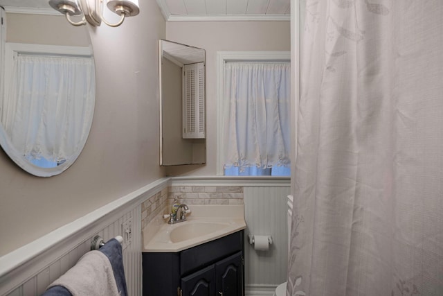 bathroom featuring crown molding and vanity