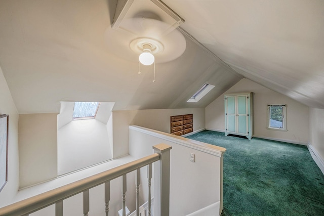 additional living space with carpet flooring and vaulted ceiling with skylight