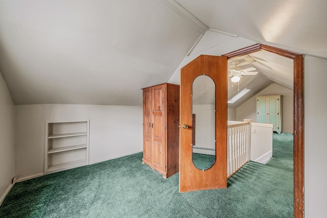 additional living space with built in shelves, ceiling fan, vaulted ceiling, and carpet