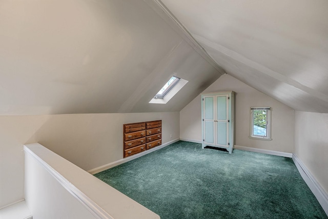 additional living space with carpet floors and vaulted ceiling with skylight