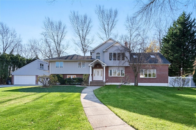 view of front facade with an outbuilding, a garage, and a front yard