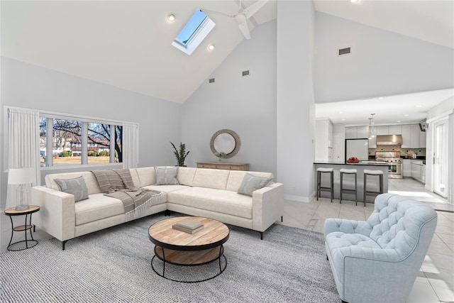 living room featuring high vaulted ceiling and a skylight