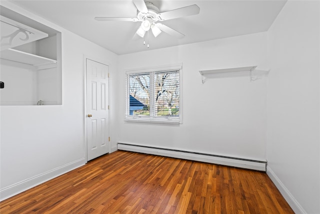 unfurnished room with baseboard heating, ceiling fan, and hardwood / wood-style floors