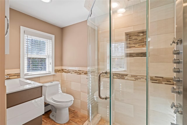 bathroom featuring walk in shower, toilet, tile walls, vanity, and a baseboard heating unit