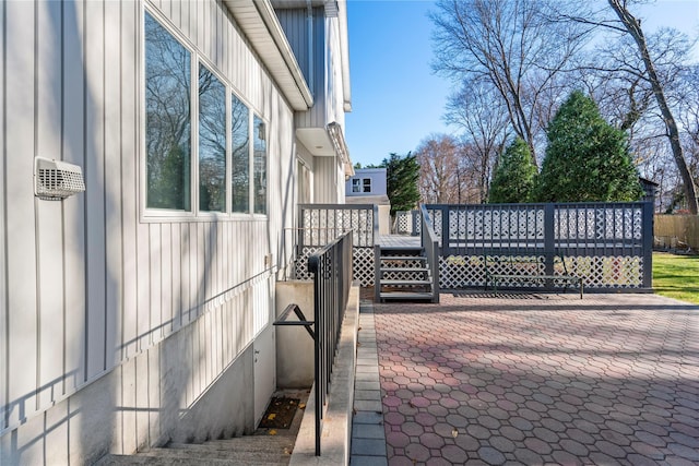 exterior space with a wooden deck and a patio