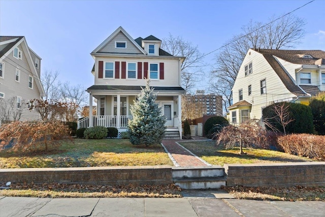 view of front of house featuring covered porch and a front lawn