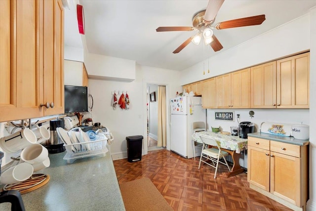 kitchen featuring light brown cabinetry, dark parquet flooring, white refrigerator, and ceiling fan