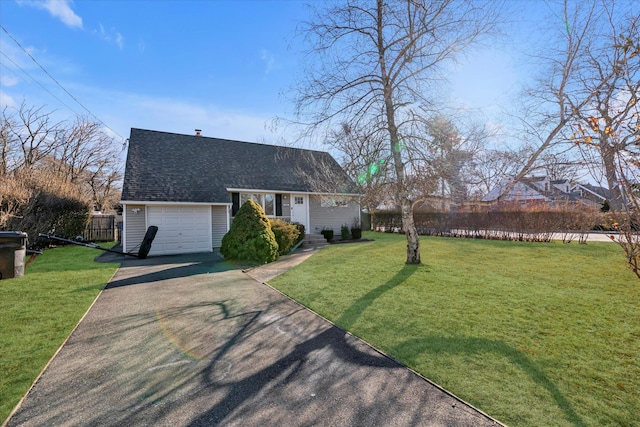 view of front of house featuring a front lawn and a garage