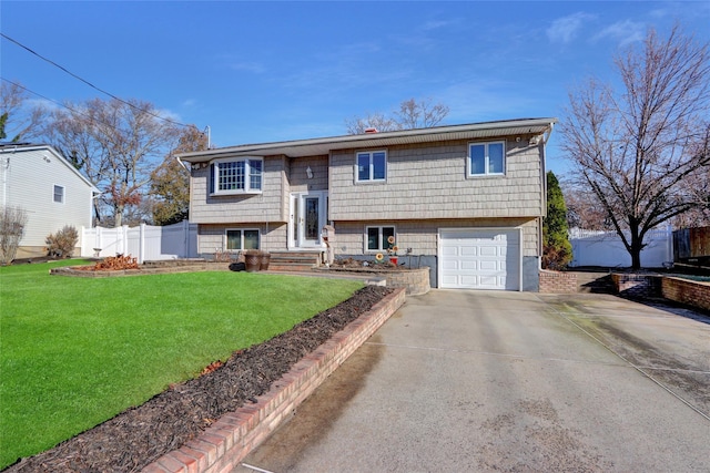 raised ranch with a front yard and a garage