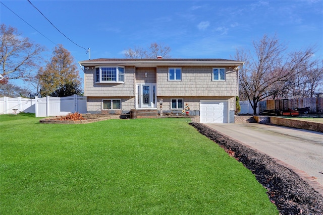 raised ranch with a garage and a front lawn