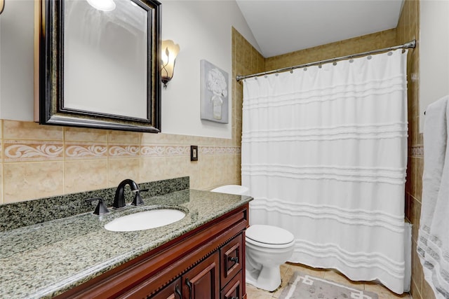 bathroom with tile patterned flooring, vanity, and toilet