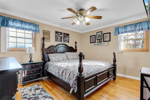 bedroom with multiple windows, ceiling fan, and light hardwood / wood-style flooring