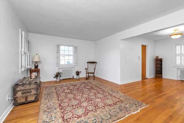 sitting room with radiator and light wood-type flooring