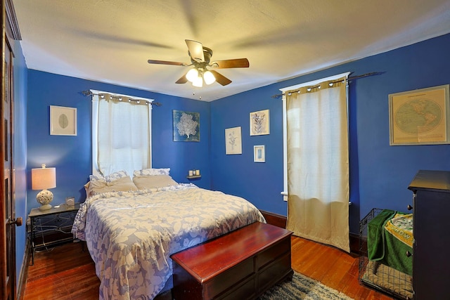 bedroom featuring ceiling fan and dark hardwood / wood-style flooring