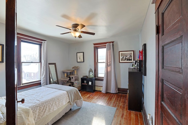 bedroom with ceiling fan and light hardwood / wood-style flooring