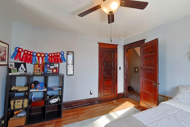 bedroom with light wood-type flooring and ceiling fan