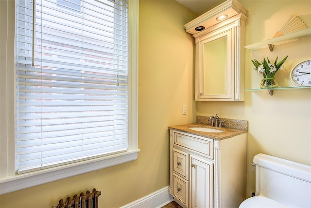 bathroom featuring toilet and vanity