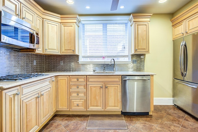 kitchen featuring sink, stainless steel appliances, backsplash, and light brown cabinets