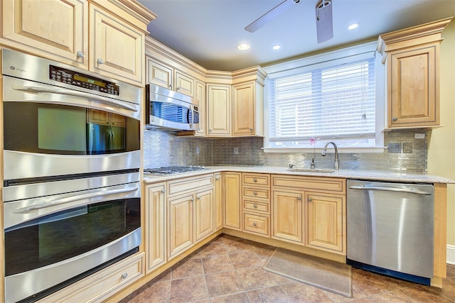 kitchen featuring stainless steel appliances, light tile patterned flooring, sink, and tasteful backsplash