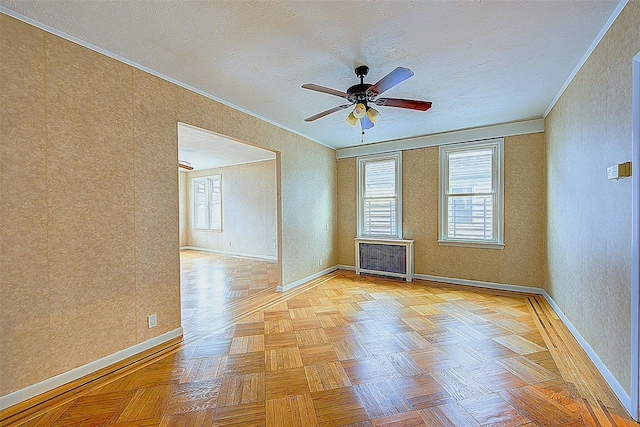 unfurnished room with a wealth of natural light, light parquet floors, and crown molding